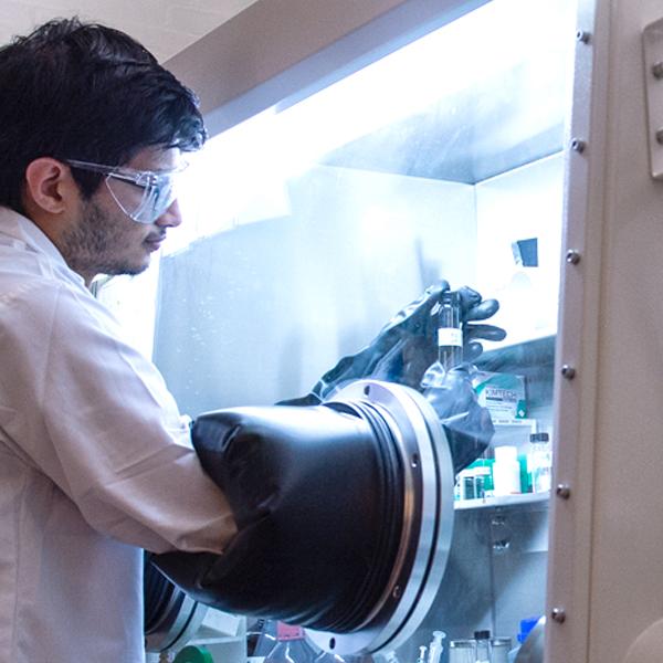 Lab technician handling sensitive material in lab